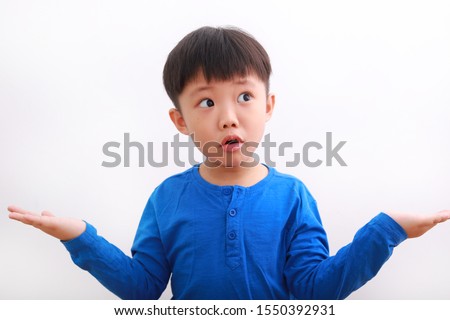 Cute little asian boy in casual wear showing his both palm with funny expression, isolated on white background.