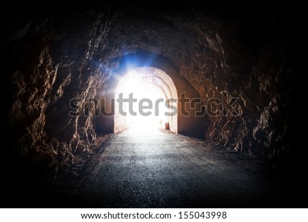 End of dark tunnel with magic blue light from the outside Royalty-Free Stock Photo #155043998
