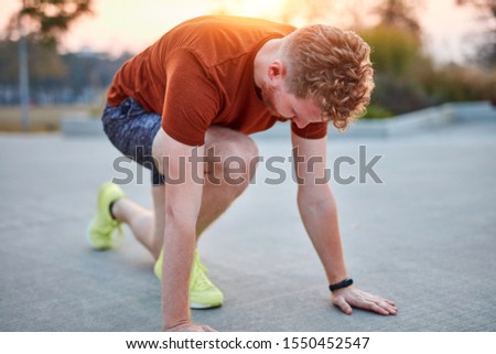 Young modern man jogging / exercising in an urban park.