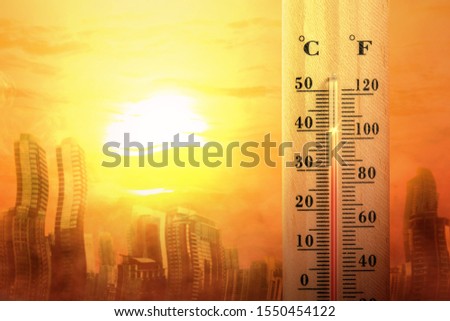 Thermometer with high temperature on the city with glowing sun background. Heatwave concept Royalty-Free Stock Photo #1550454122
