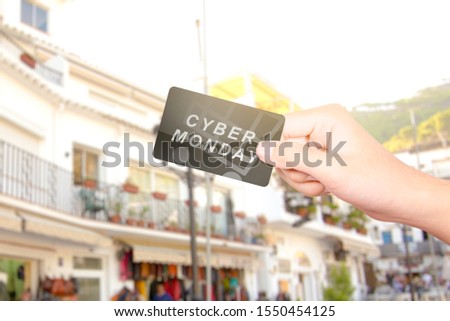 Hand holding the card with Cyber Monday text. Cyber Monday concept