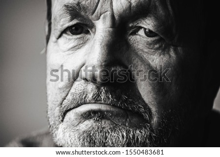 Sad pensive elderly man with mustache close-up portrait