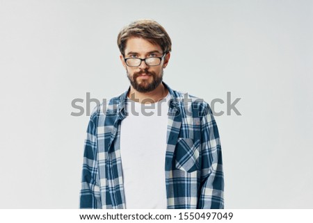 Close-up cropped look handsome man in a plaid shirt and t-shirt