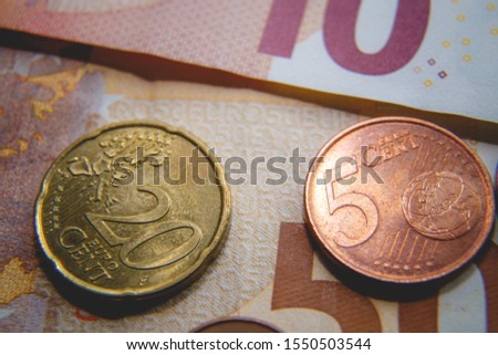 Macro photo of Euro coins on a blurred background banknote in 10 and 50 euro. Money background. Extremely small depth of field.