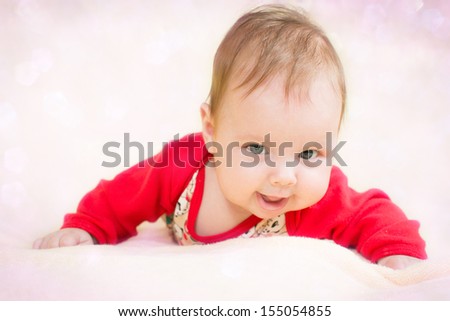 4 months baby girl on a glitter bokeh background