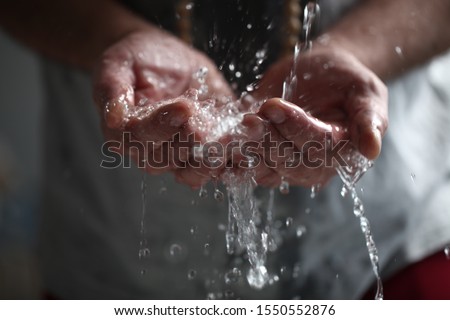  man washes his hands a ritual ceremony before prayer Royalty-Free Stock Photo #1550552876