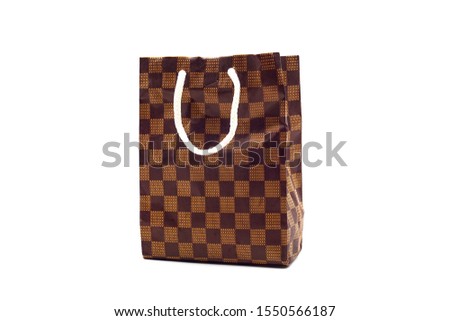 Shopping bag image. Checkered paper bag isolated on white background.