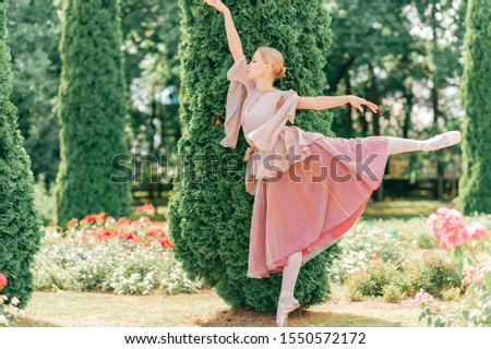 Elegant ballerina shows ballet poses in beautiful italian garden