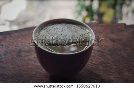 Close Up of Coffee mug cup on wooden table in natural Vintage effect style pictures