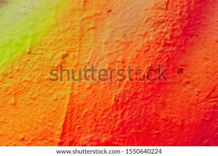 Fragment of colored graffiti painted on a wall. Abstract background for design. Urban style.