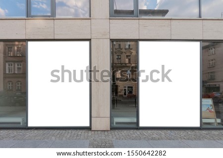 Mockup of the blank white street city outdoor advertising vertical billboards in black frames at corporate building window