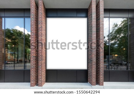 Mockup of the blank white street city outdoor advertising vertical billboard on black and brick building wall