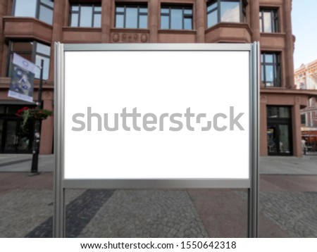 Mockup of the blank white street city outdoor advertising horizontal poster stand in silver frame at city sidewalk