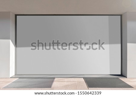 Mockup of the blank white street city outdoor advertising horizontal  billboard in silver frame at shop window