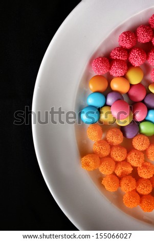 Mixed colorful candy on black background