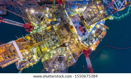 Aerial view offshore jack up rig at night, Offshore oil rig drilling platform, Maintenance. Royalty-Free Stock Photo #1550675384