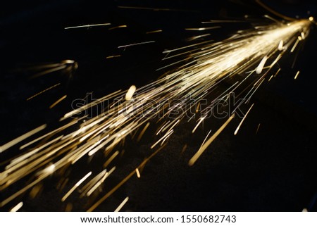 Bright blue and yellow sparks on a black background. Magical lig