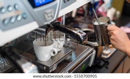 Coffee in white cup on a coffee machine