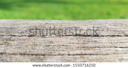 Blank top wood table in blurred nature park background,de-focus
