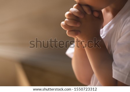 Asian boy praying in the morning with hands held together 