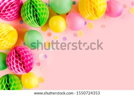 Balloons and confetti on pink background.  Birthday, holiday concept. Flat lay, top view. Birthday party background