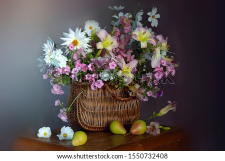 Beautiful bouquet of white and pink flowers in a wicker basket.Still life of summer flowers.