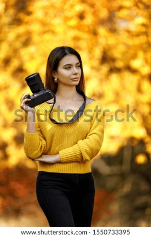 cute girl photographer takes pictures in nature, the photographer in action