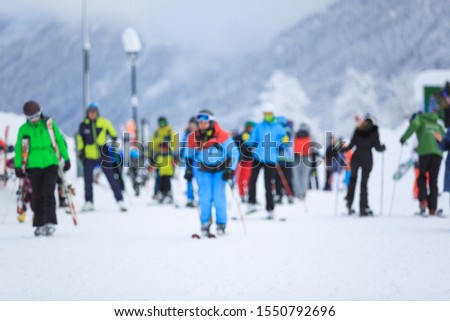 Happy skiers and snowboarders having fun at ski resort. Winter vacations concept
