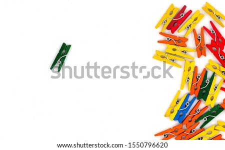 colored wooden clothes pegs on white background