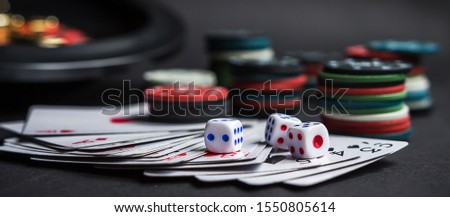 Gambling .Close-up cards for playing poker on a gaming table in a casino against a background of chips. Background for a gaming business.Long banner