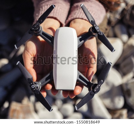Small compact drone in womans hands