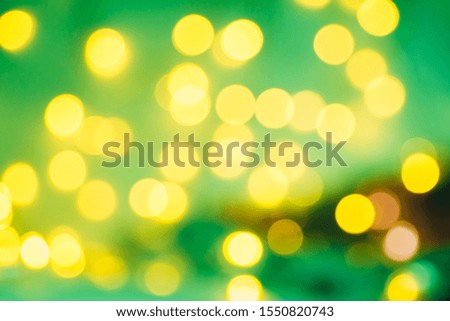 Christmas background. Festive green abstract background with bokeh defocused lights and stars