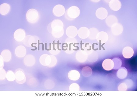Christmas background. Festive violet abstract background with bokeh defocused lights and stars