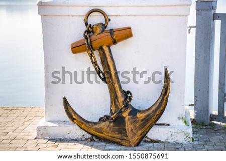 Old historic ship anchor on white  background