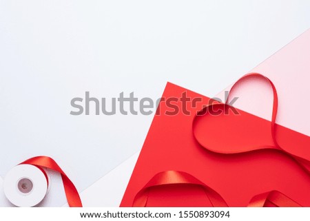Top view of ribbon shaped as heart on colorful background. Valentine's day concept