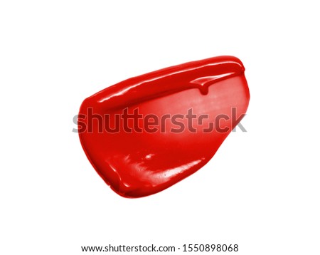 Liquid lipstick smear smudge swatch isolated on white background. Red lip gloss texture. Shiny makeup product brushstroke sample