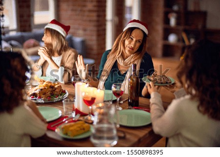 Beautiful group of women smiling happy and confident. Eating roasted turkey celebrating christmas at home