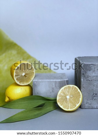 Lemons on a cube on a gray background.  Lemon fruit composition background for a beauty salon