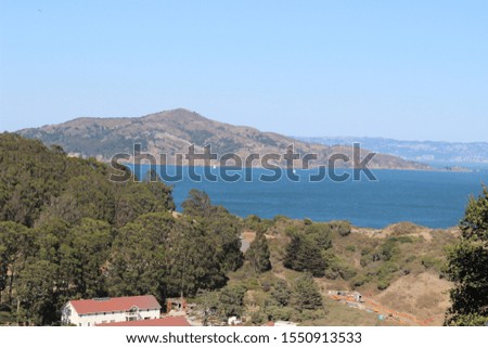 Beautiful scenic view of the ocean, island, vacation houses, mountains and trees
