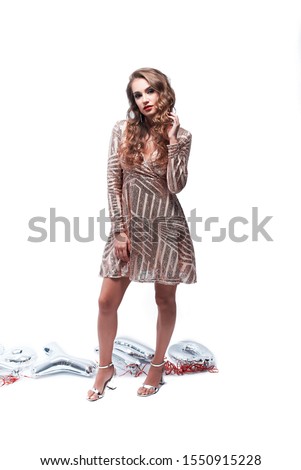 Happy young woman in elegant dress against white background. New Year celebration and Christmas. Copy space.