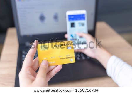woman holding credit card and use phone for with shopping online. Online payment concept.