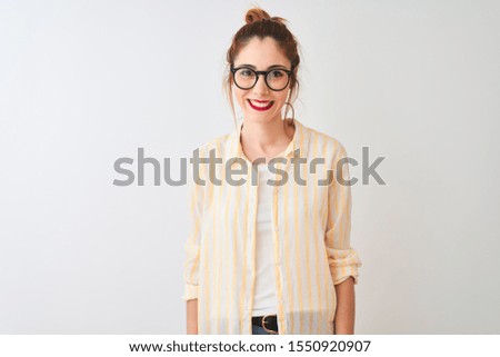 Redhead woman wearing striped shirt and glasses standing over isolated white background with a happy and cool smile on face. Lucky person.