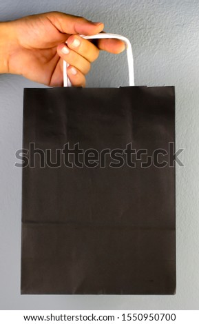 Black friday discount day bag. Blank space for your logo and design. Shopping package in a man's hand