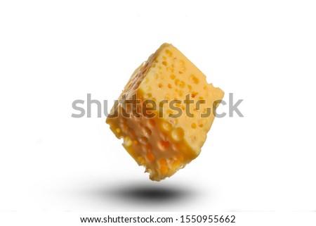 There is flying yellow/gold piece of cheese on the white background. Merry Christmas. Happy New Year 2020. 
