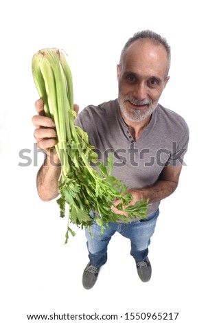 portrait of a man with celery on white background