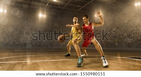 Basketball players in action on professional arena. Players wear unbranded clothes. Stadium made in 3D.
