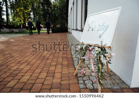 Wedding. Reception. Handmade wooden board with welcome sign on it decorated with eucalyptus