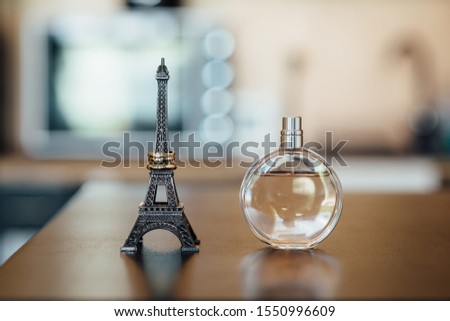 wedding rings on a eiffel tower statue on a wooden table