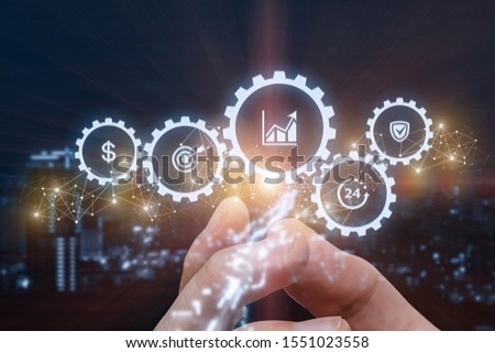 Concept of successful business management. Hand represents a mechanism of control on blurred background.