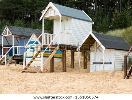 A row of different style beach huts